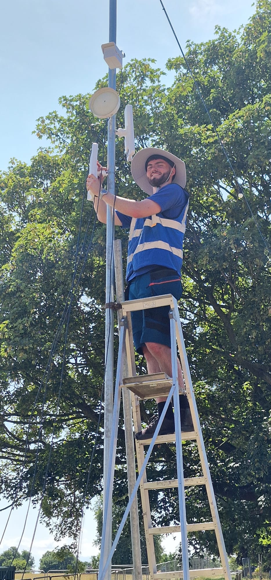 HTG engineer Nathan installing wireless equipment at Deershed Festival 2026