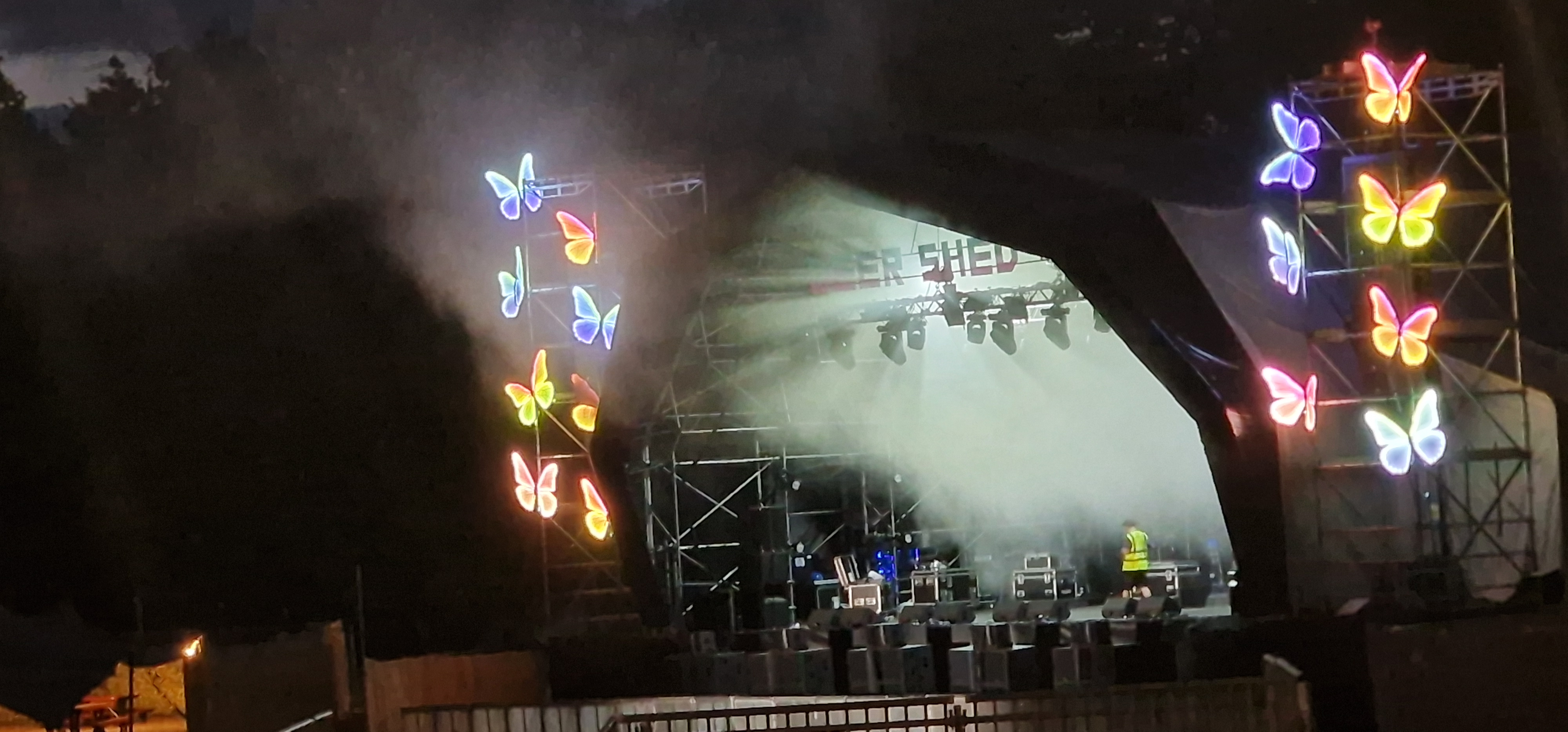 Deershed main stage at night with full butterfly lighting rig and stage production lighting