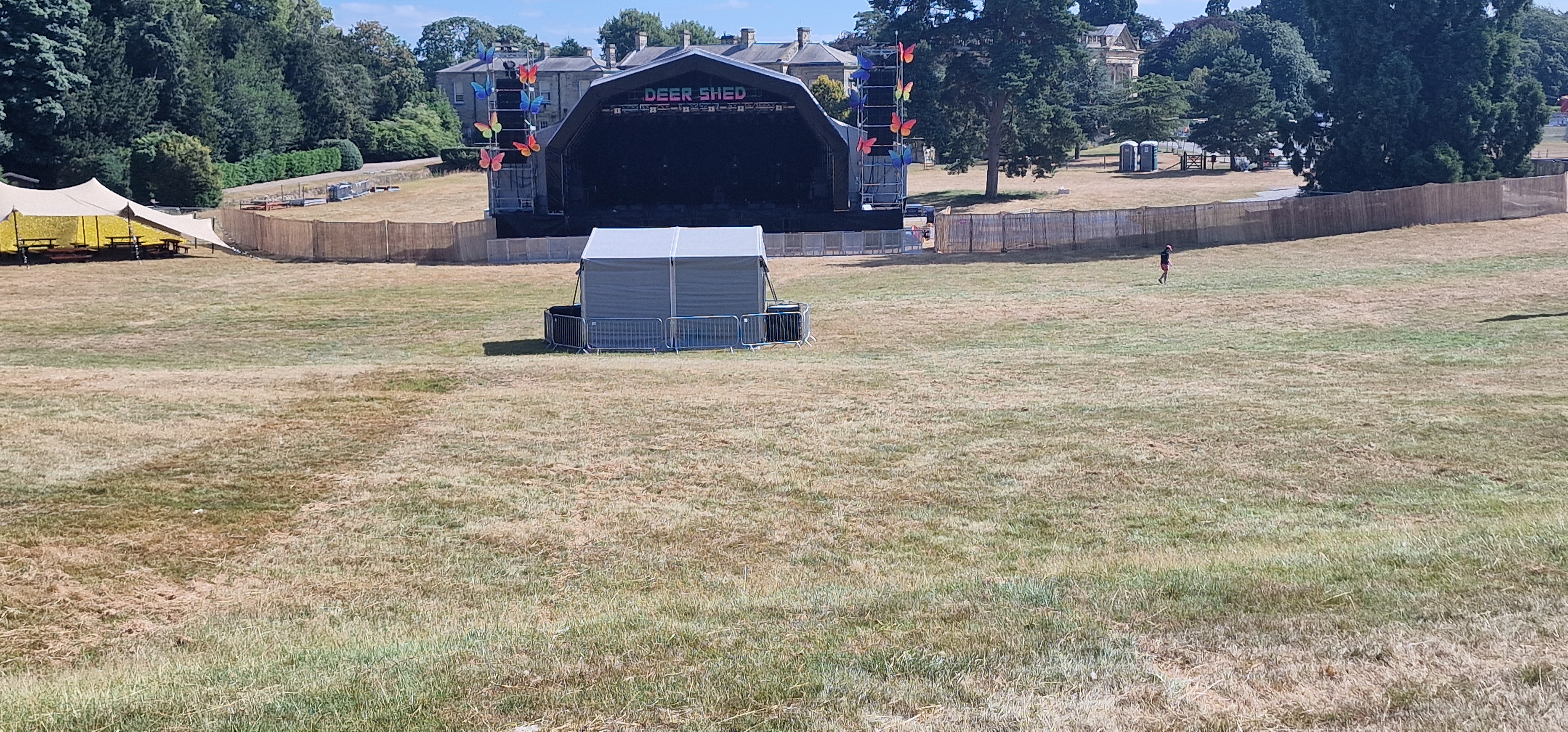 Deershed main stage with butterfly lighting rig and estate house behind on opening morning