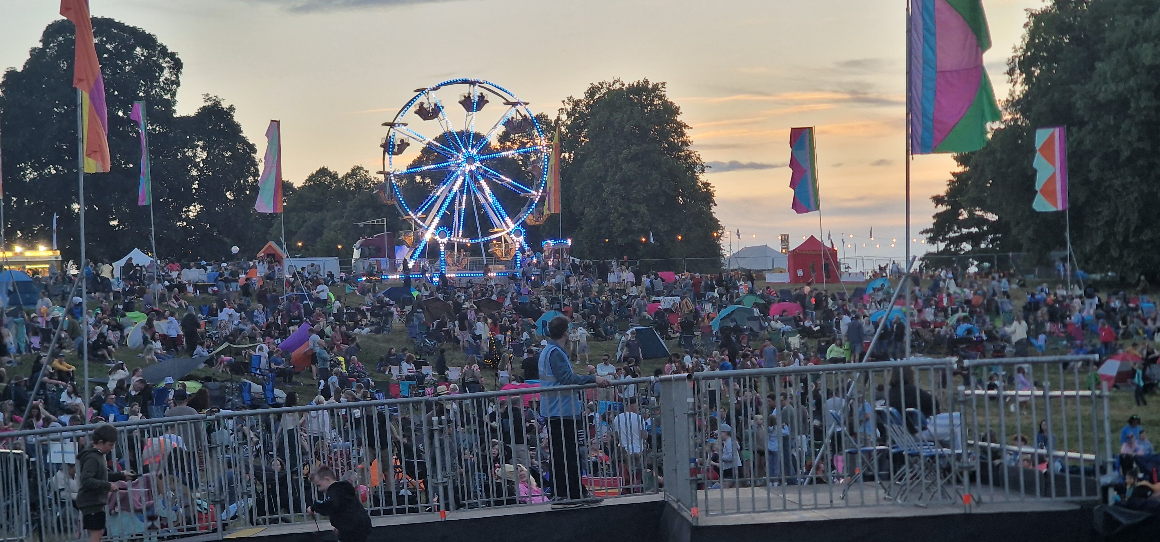 Deershed Festival 2026 ferris wheel lit at dusk with crowds on the hillside